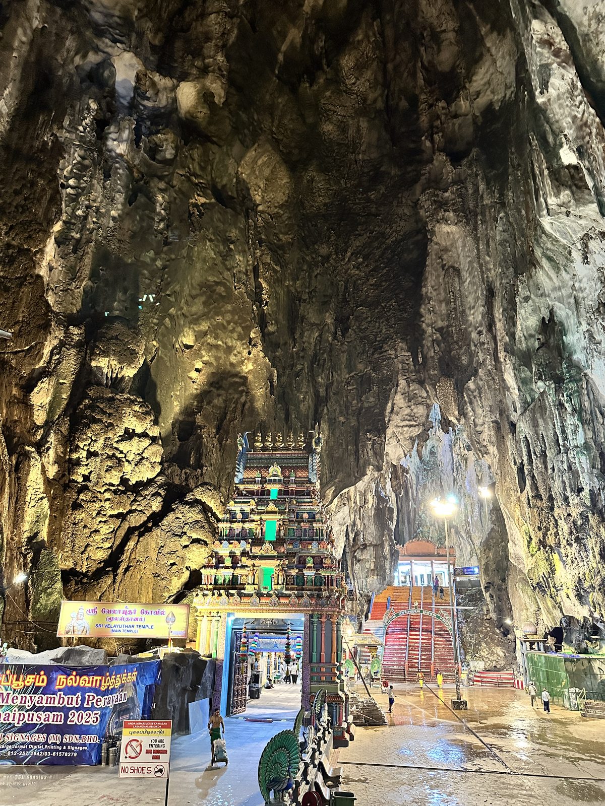 The interior of the Temple Cave at Batu Caves, an enormous limestone cavern with a colourful temple gopuram built inside it