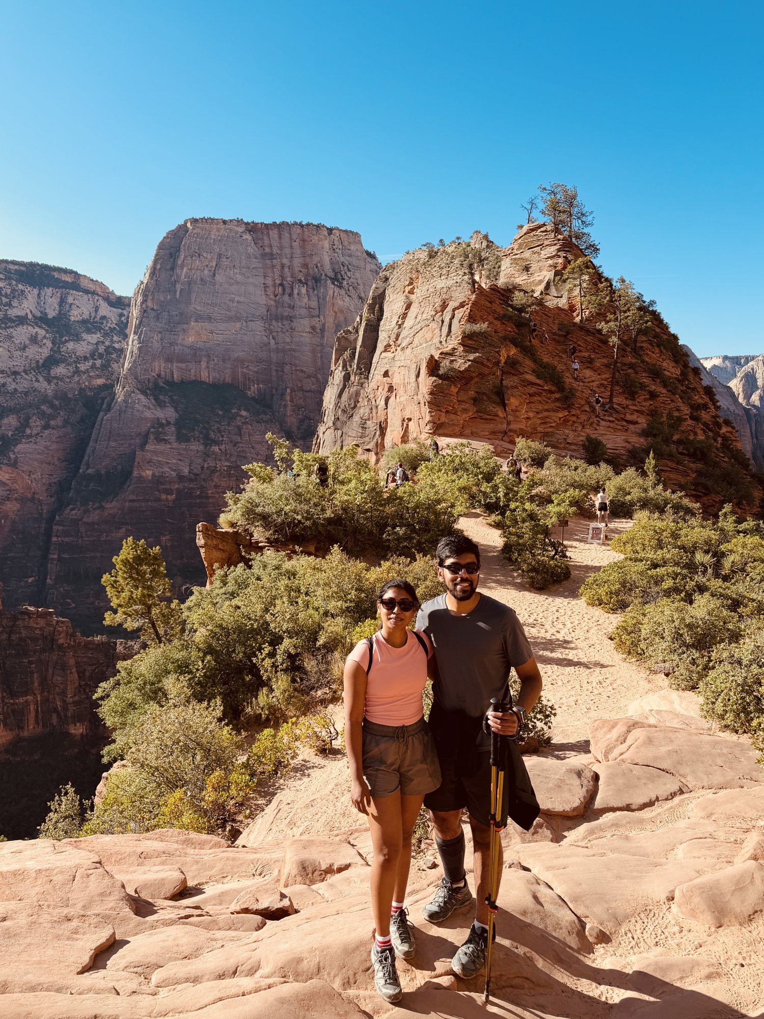 Two hikers on a trail in Zion Canyon