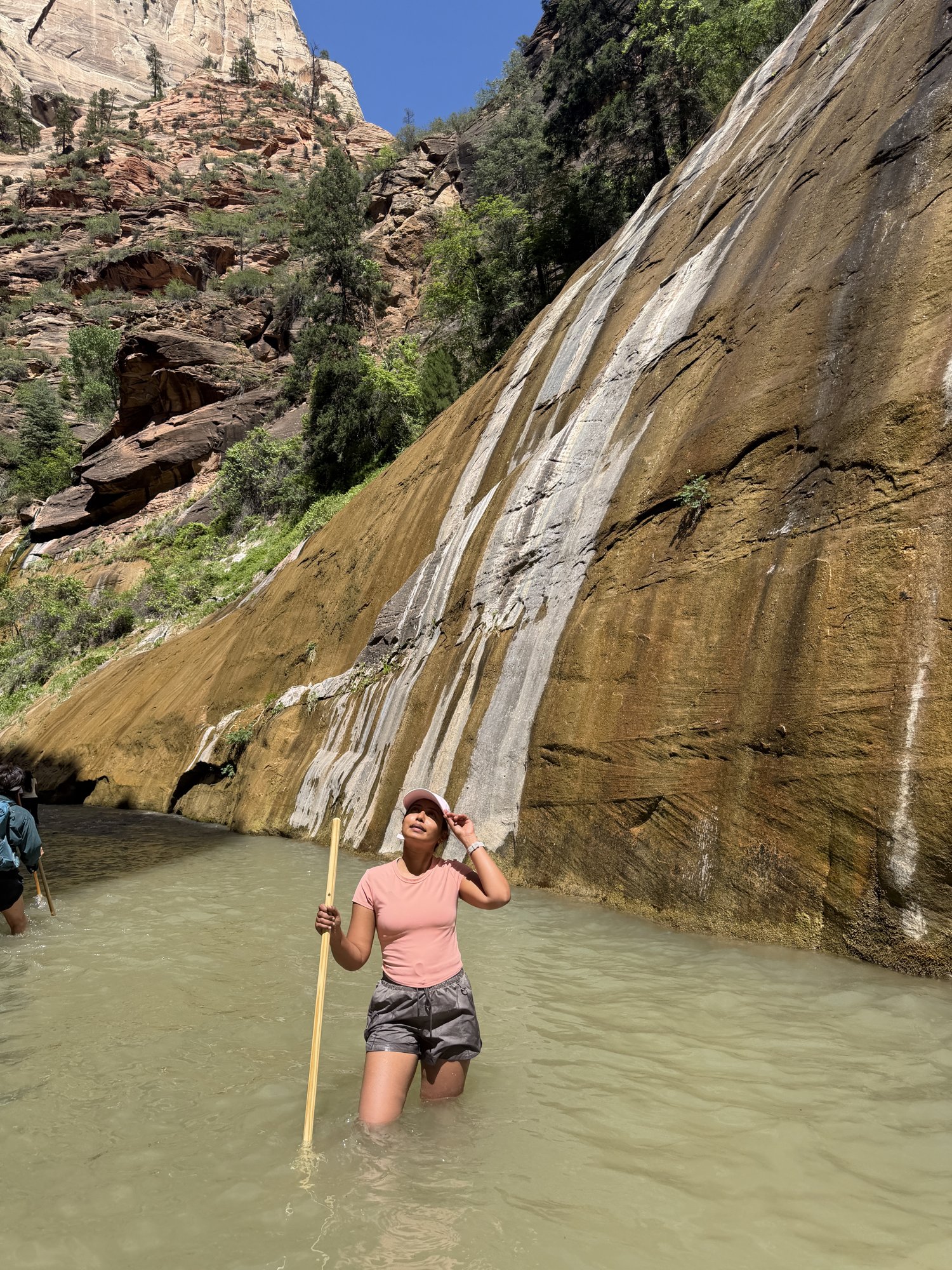 Wading up the river through the slot canyon of the Narrows in Zion