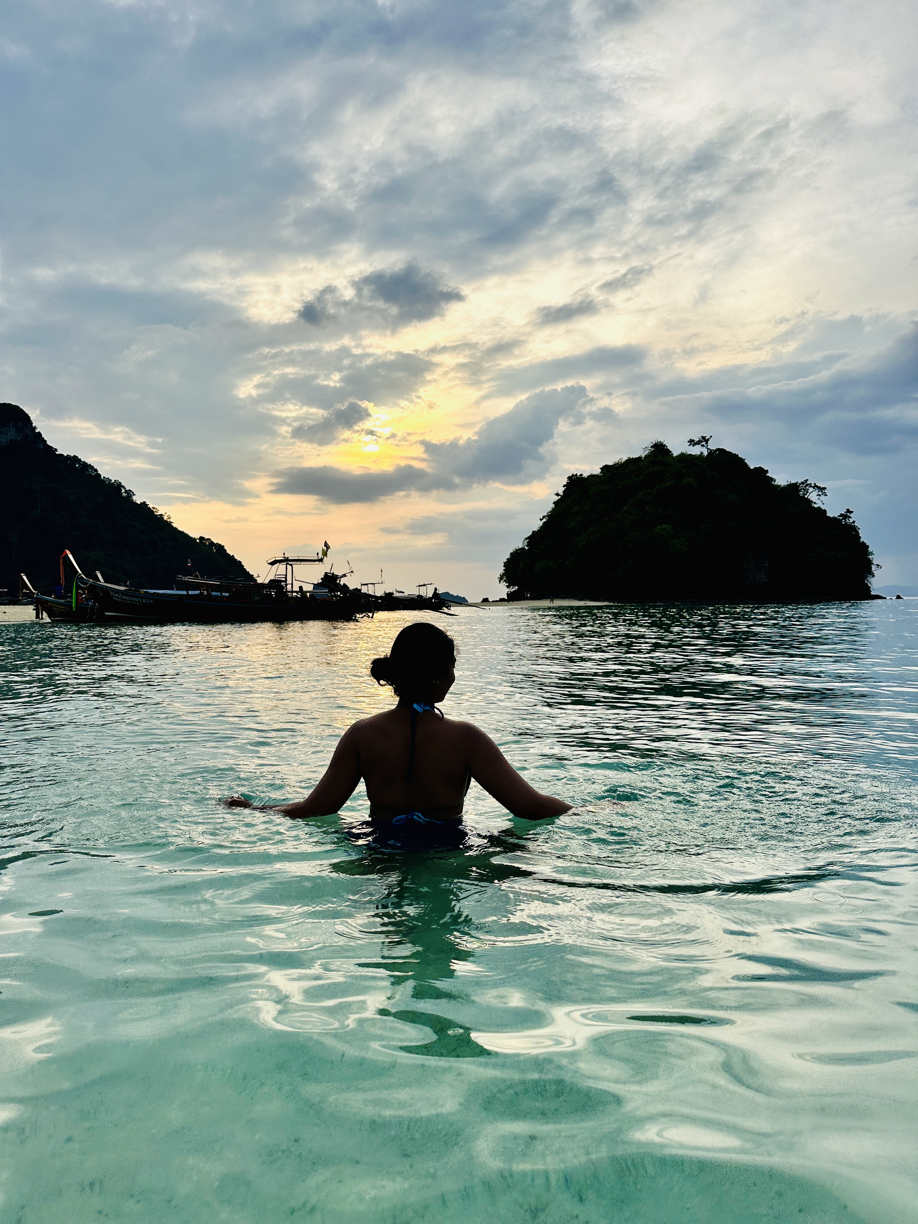 Longtail boats and limestone karsts off Railay at sunset