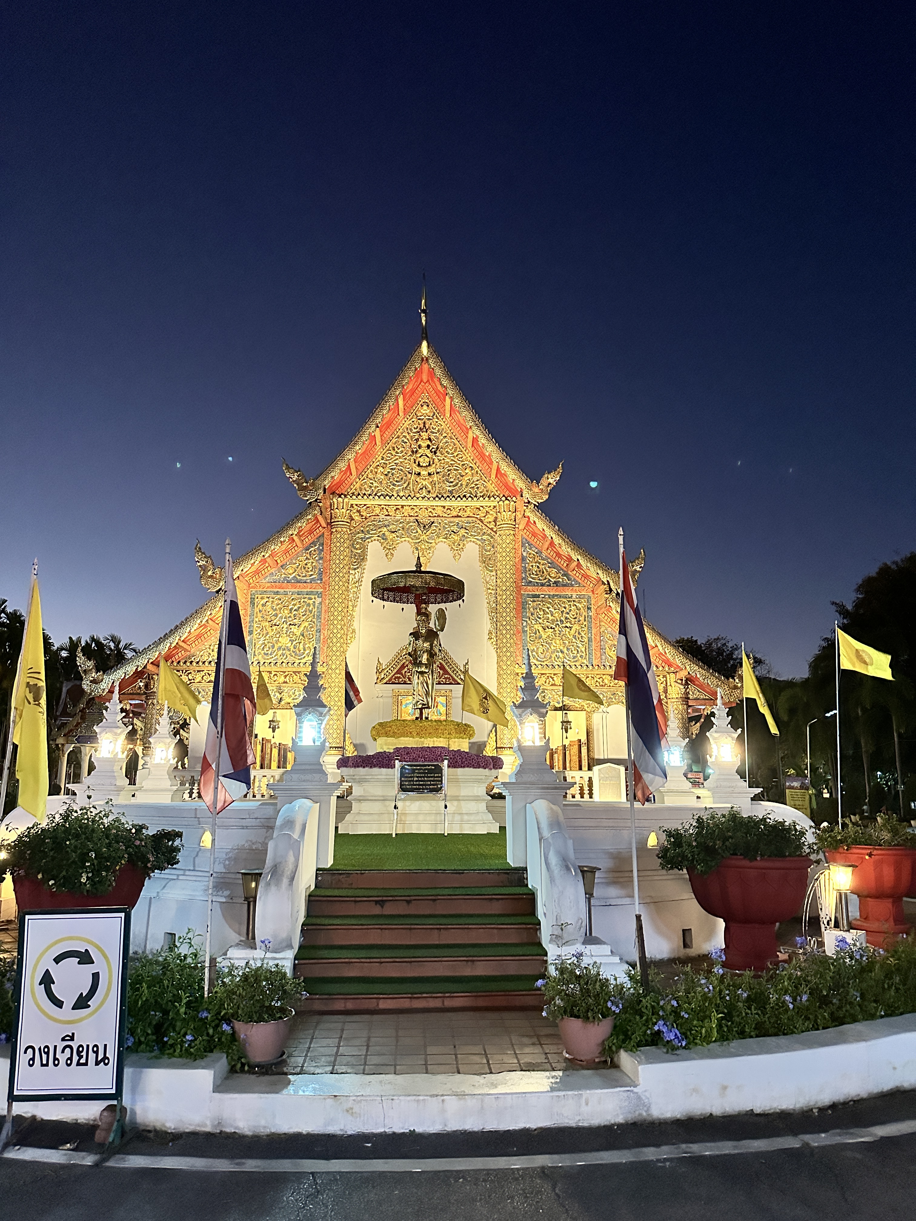 Wat Phra Singh in Chiang Mai lit gold against a deep blue night sky