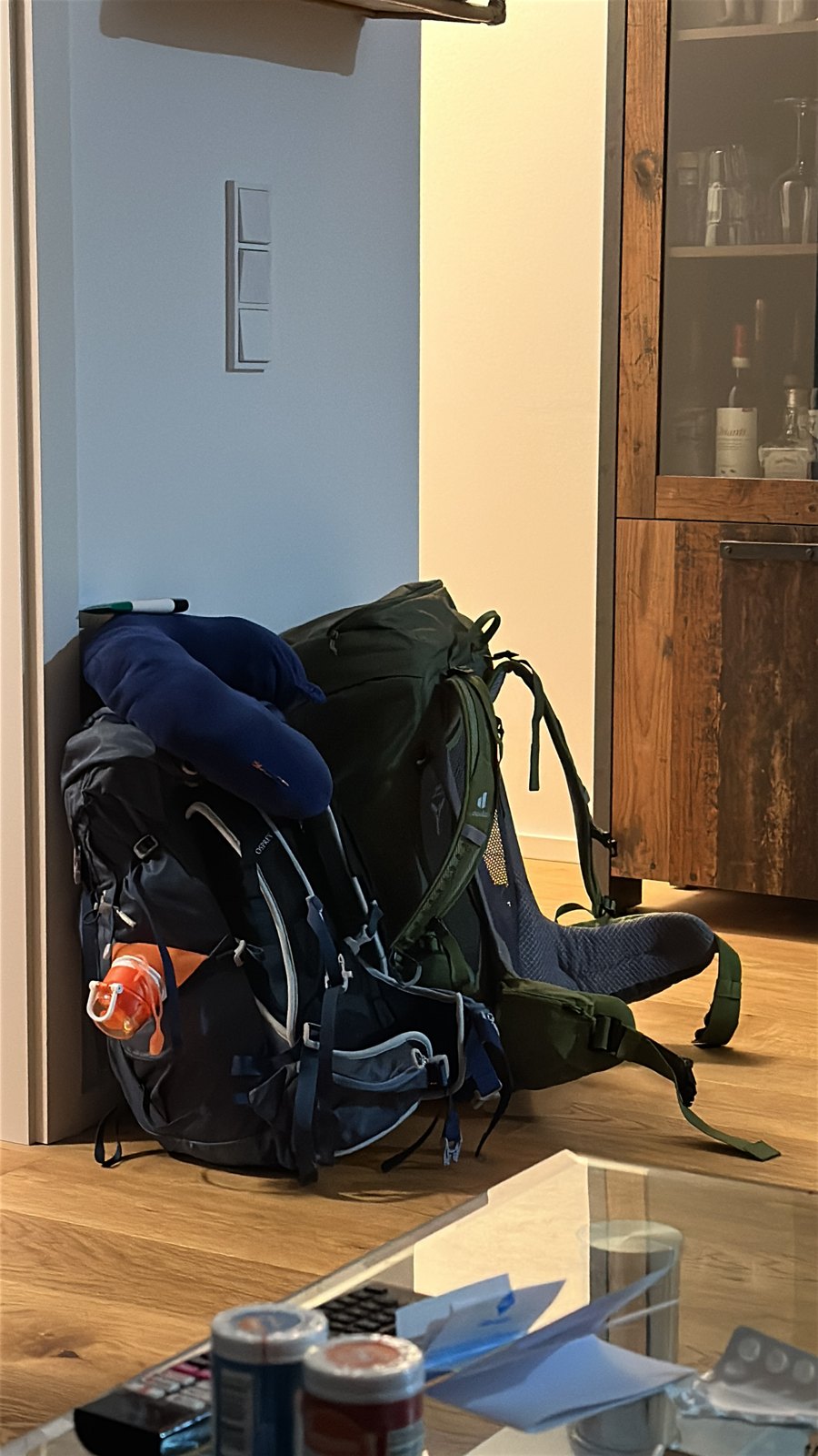 Two large trekking rucksacks packed and standing against a wall in a flat in Munich the night before departure