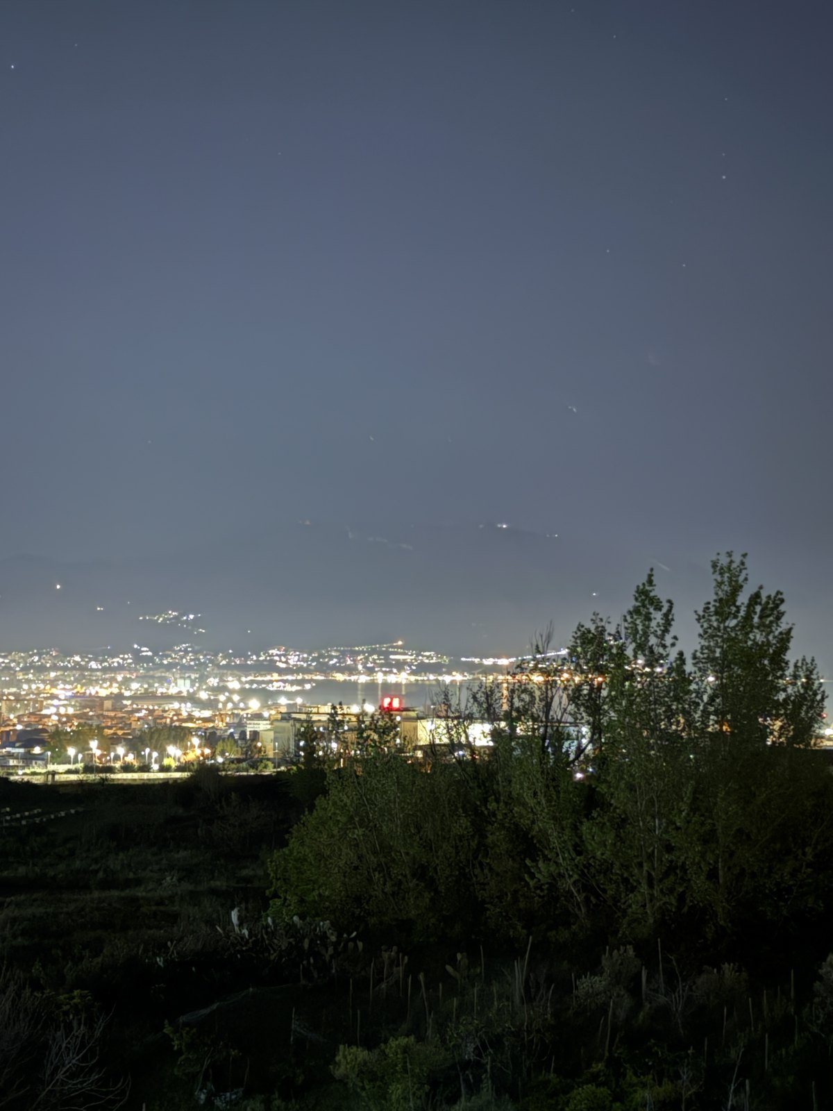 The lights of the towns around the Bay of Naples at night seen from high on the slopes of Vesuvius